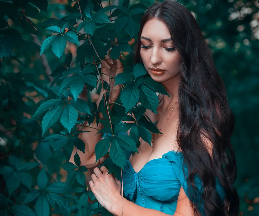 Subtelny kobiecy portret pośród liści drzewa