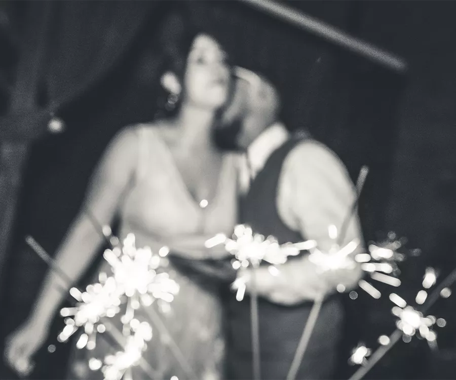 Rozmyte zdjęcie młodej pary z zimnymi ogniami na pierwszym planie